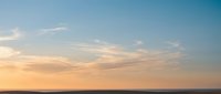 Serene sunset sky with soft pastel clouds over horizon creating peaceful evening atmosphere for meditation wellness and relaxation backgrounds.