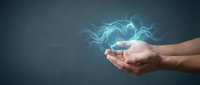 Human hands cupping glowing blue energy with electric lightning effects on dark background for technology and power concepts.