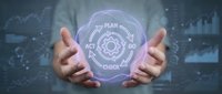 Hands holding glowing plan check hologram with digital interface, representing business strategy, quality assurance, and technology innovation in corporate environment.