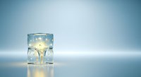 Glowing lightbulb suspended in clear liquid inside glass cube on reflective surface against blue gradient background, symbolizing innovation and creative ideas for business and technology concepts.