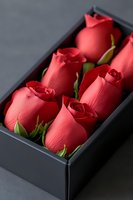 Red roses arranged in elegant black gift box for romantic occasions and special celebrations.