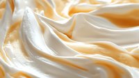 Creamy white and golden swirls create luxurious soft waves and folds in smooth texture, suitable for food industry backgrounds and dessert presentations.