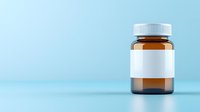 Brown medicine bottle with blank white label on light blue background, minimalist pharmaceutical mockup for supplement or prescription drug packaging design.