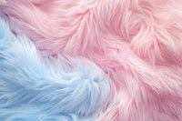 Soft pink and blue faux fur texture background with fluffy, luxurious appearance. Abstract pastel colored synthetic material surface creates dreamy atmosphere.