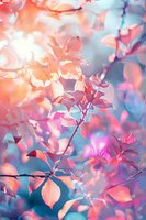 Delicate coral and turquoise leaves create dreamy natural backdrop with soft bokeh effect and ethereal lighting, suitable for romantic or wellness designs.