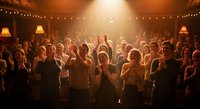 Crowd of people dancing and celebrating at indoor party with warm golden lighting and string lights creating festive atmosphere for entertainment events.