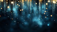 Magical glowing golden bokeh lights falling on dark turquoise background with sparkles and light effects creating dreamy atmospheric backdrop.