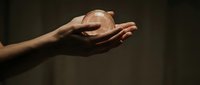 Protective cupped hands gesture against dark background symbolizing care, security and safeguarding concepts for business and personal protection themes.