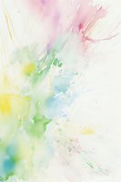 Soft pastel watercolor splash in pink, yellow, green and blue hues on white background creates dreamy abstract pattern for creative design projects.