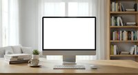 Modern computer monitor with blank white screen on wooden desk in bright home office with bookshelf background for mockup presentations and design work.
