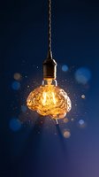Brain-shaped light bulb with glowing filament on dark blue background with bokeh lights representing creativity and innovation concepts.
