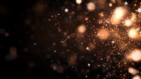 Magical golden bokeh lights scattered on dark background with glowing particles and sparkles creating dreamy atmospheric effect for festive designs.