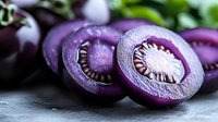 Fresh sliced purple carrots showing vibrant cross-sections with detailed inner patterns and seeds on dark stone background, macro food photography.