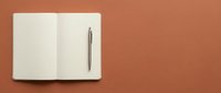 Open notebook with blank pages and pen on terracotta background, ready for writing, planning, journaling, business notes, education, and creative projects.