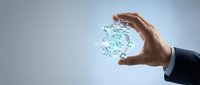 Businessman hand holding glowing digital sphere with binary code data representing technology innovation and digital transformation concepts.