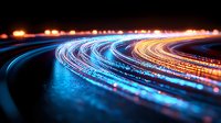 Curved light trails glowing in blue and orange colors against dark background, long exposure photography creating dynamic motion effect on highway at night.