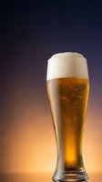Fresh golden beer with white foam head in tall glass against gradient background for beverage advertising and restaurant marketing materials.