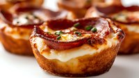 Crispy bacon and egg cups baked in golden muffin tins with fresh herbs, perfect breakfast appetizers for brunch gatherings and morning meal preparation.
