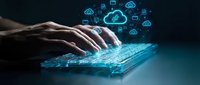 Hands typing on glowing digital keyboard with cloud computing icons and data symbols floating above in futuristic technology concept for business innovation.