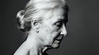 Senior woman with gray hair in profile, showing natural aging skin texture and wrinkles, suitable for healthcare, wellness, and aging-related design projects.