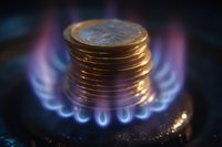 Stack of gold coins on burning gas stove burner with blue flame, symbolizing energy costs, rising prices, and economic pressure in utility sector.