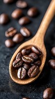 Fresh roasted coffee beans in wooden spoon on dark background, macro shot with selective focus. Aromatic whole beans for brewing espresso or coffee.