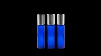 Cobalt blue glass roller bottles with metallic silver caps, isolated on transparent background. Ready for cosmetics, essential oils, perfume packaging design, sublimation, print-on-demand products, and branding mockups.