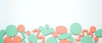 Colorful paper cut circles and wavy shapes in mint green and coral pink creating abstract geometric border on white background for creative projects.