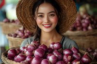 Young Asian woman in straw hat smiling while holding fresh red onions at farmers market, surrounded by woven baskets full of organic produce.