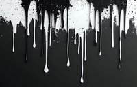 White paint drips and splatters flowing down on black background, creating dramatic contrast effect. Liquid drops pattern for grunge design projects.