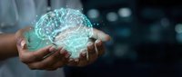 Glowing digital brain hologram floating above cupped hands representing artificial intelligence, neuroscience, and innovative technology concepts.