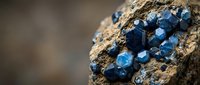 Blue sapphire crystals embedded in natural rock formation with geometric hexagonal structure for jewelry and gemstone collection purposes.