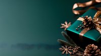 Elegant emerald green gift box with copper ribbon, pine cones and metallic snowflake decorations on dark background. Festive holiday composition.