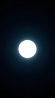Bright full moon glowing against dark night sky with luminous halo effect, suitable for astronomy, celestial, and nighttime themed designs and backgrounds.