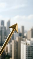 Golden arrow pointing upward against blurred city skyline representing business growth, success, achievement and financial progress in urban environment.
