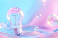 Glowing light bulb on soft pink and blue background with floating soap bubbles creates dreamy atmosphere for creative and innovative concepts.