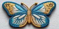 Embroidered butterfly patch with blue and gold wings, detailed stitching, and intricate wing patterns on white fabric background.