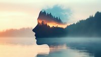 Double exposure silhouette of woman's face blended with misty lake landscape and forest at sunset, creating dreamy atmospheric mood for wellness and mindfulness concepts.