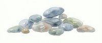 Polished gemstones and healing crystals in various colors including blue, green, and brown tones isolated on white background for jewelry design and wellness product use.