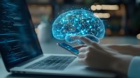 Glowing blue digital brain hologram floating above smartphone with laptop in background, representing artificial intelligence and machine learning technology.