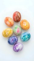 Colorful watercolor painted Easter eggs isolated on white background, arranged in circular pattern. Vibrant hand-dyed eggs in rainbow hues including red, orange, yellow, green, pink, blue, and purple for holiday celebrations and seasonal designs.