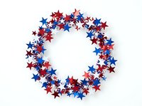 Patriotic star wreath with red, white and blue stars arranged in circular frame on isolated white background, ready for holiday designs.