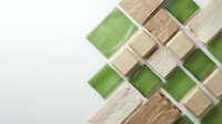 Wooden and green cube blocks arranged in geometric pattern on white background for creative design projects and educational materials.