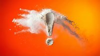 Exclamation mark symbol exploding with white powder burst on vibrant orange gradient background for attention-grabbing designs and marketing materials.