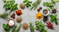Fresh herbs and aromatic spices arranged on textured surface for culinary cooking and seasoning. Natural ingredients for healthy recipes and gourmet dishes.