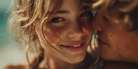 Young blonde woman with freckles smiling warmly in golden sunlight, natural beauty portrait with soft lighting and carefree summer mood for lifestyle content.