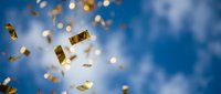 Golden confetti pieces falling through bright blue sky with soft clouds creating celebratory atmosphere for party decorations and festive designs.