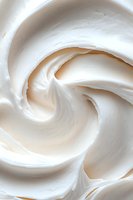 Creamy white meringue swirls create an elegant spiral pattern, showcasing soft peaks and smooth texture in close-up macro photography for culinary and dessert designs.
