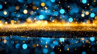 Magical glowing bokeh lights reflected on shimmering surface with golden sparkles and blue orbs creating dreamy abstract background for festive designs.