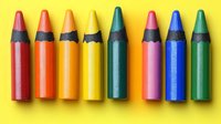 Colorful wax crayons arranged in row on yellow background. Close up view of red, orange, yellow, green, pink and blue drawing supplies for children education.
